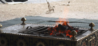 A portable fire being used in the desert