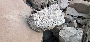 A piece of faroush lying in the remains of an old house