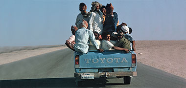 Workers being transported on a pickup, 1972