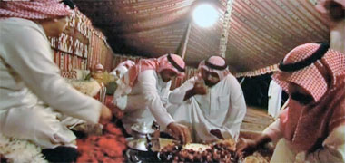 Guests eating a traditional meal in a tent