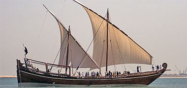 A bateel with both its sails set 