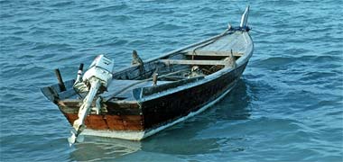 A small craft with outboard motor in the dhow harbour in Doha