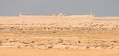 A distant view of a villa in the desert