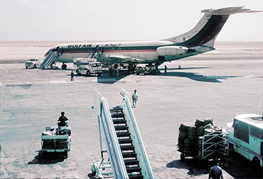 A Gulf Air flight standing on the apron adjacent to the terminal building, October 1976