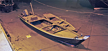 Two small boats moored at night