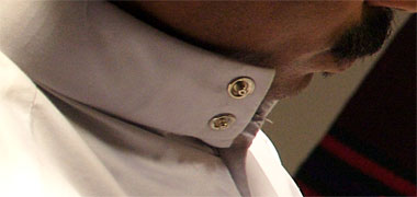 A pair of press studs used to close a stand-up collar