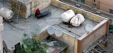 Water tanks and a bed on top of a building