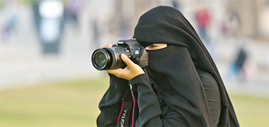A young Qatari woman taking photographs in public – with permission from Gábor Somogyi-Tóth on Flickr